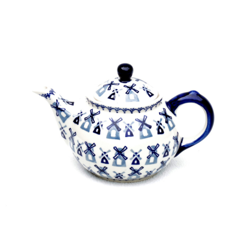 Hats and sweaters on wood shelves next to various colors of t-shirts on hangers.