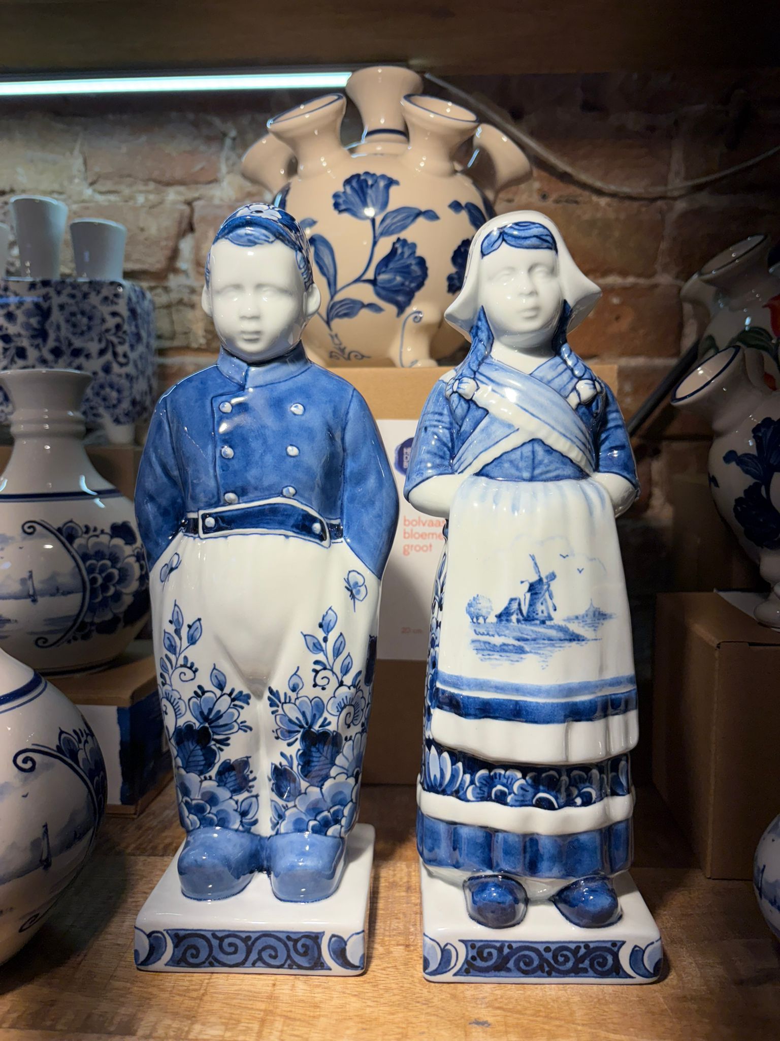 Brown leather key ring with brass metal loops and rivets on wood table.